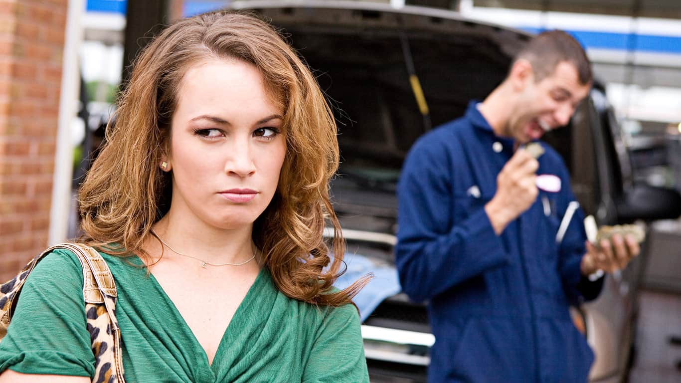 Person looking at car engine confused